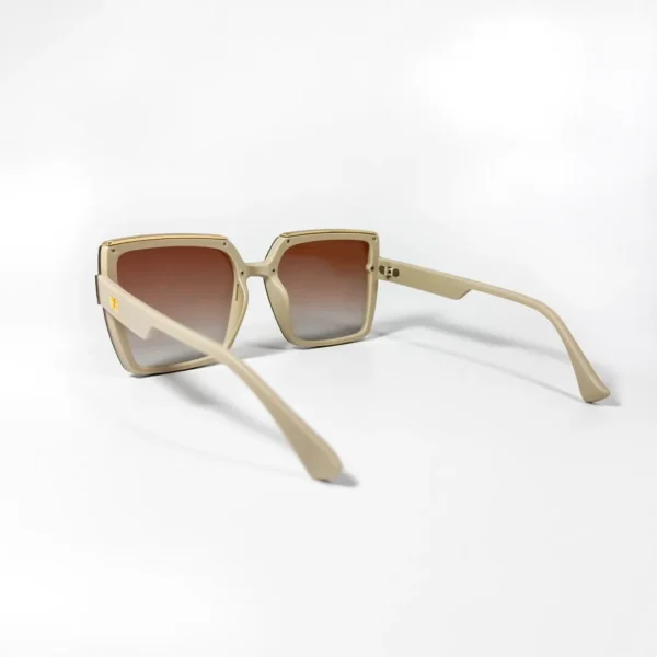 Oversized square sunglasses with a cream-colored frame, brown-to-clear gradient lenses
